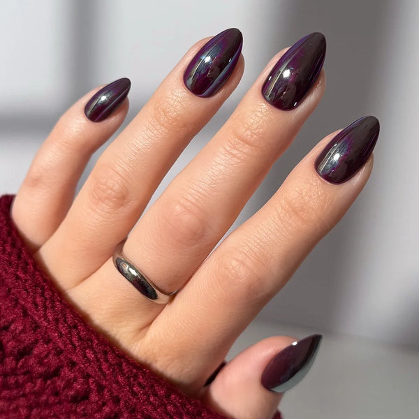Deep plum gel nails with a copper chrome finish