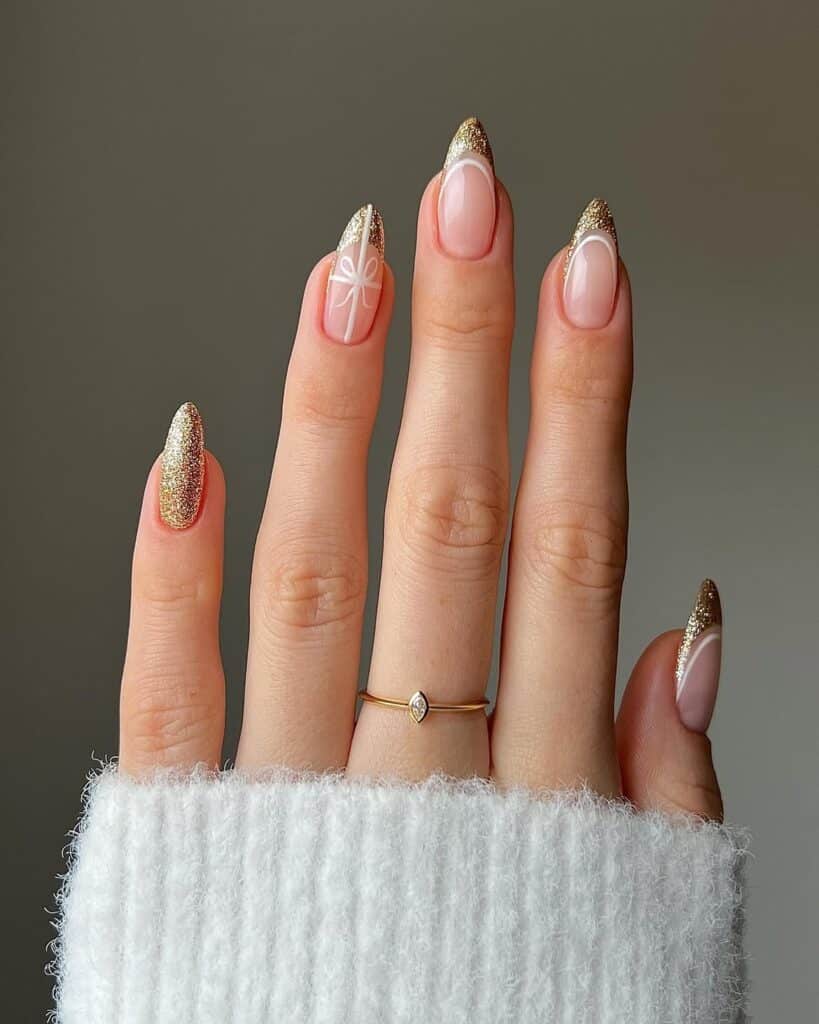 Champagne gold French tip oval nails with holiday shimmer