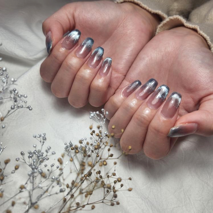 Silver magnetic cat-eye nails on a sheer grey base