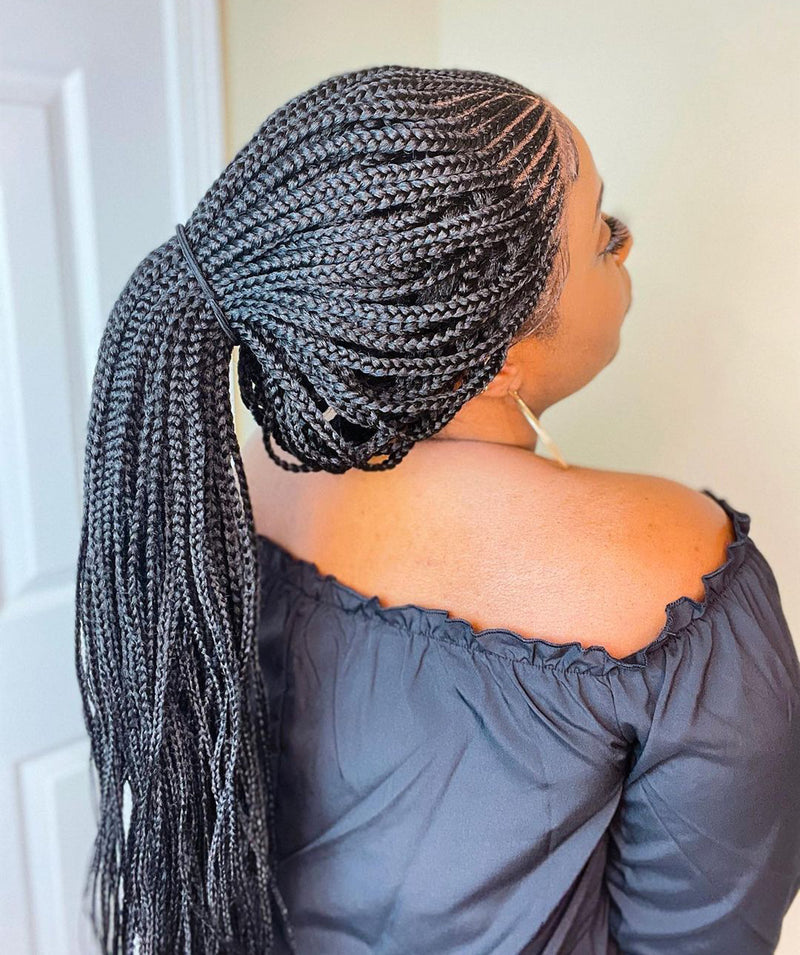 Cornrows pulled into a long braided ponytail