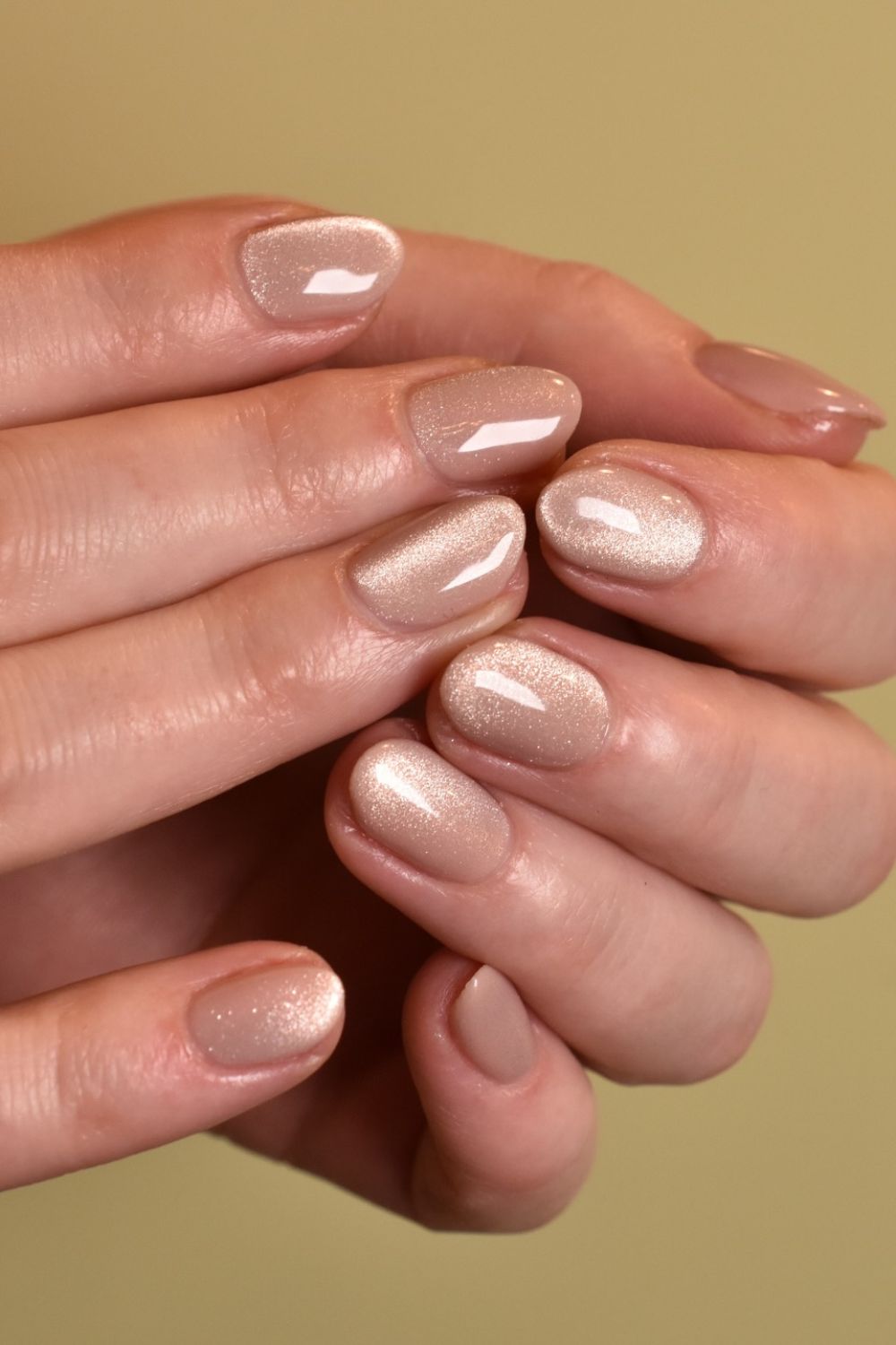 Warm Champagne Nude: a nude-gold polish on medium oval nails