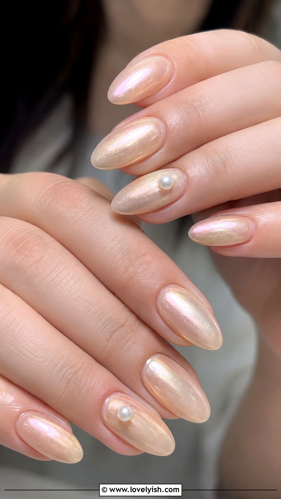Pearl Champagne: an iridescent champagne pearl with pearl gem accents on almond nails