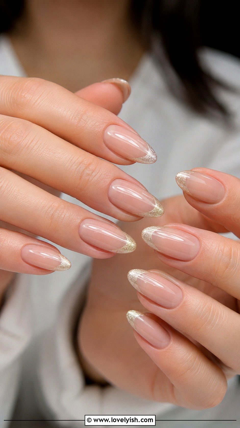Champagne Glitter Accent: glittery champagne-gold French tips on almond nails
