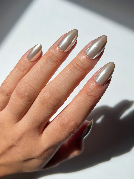Champagne chrome nails with a soft golden metallic sheen