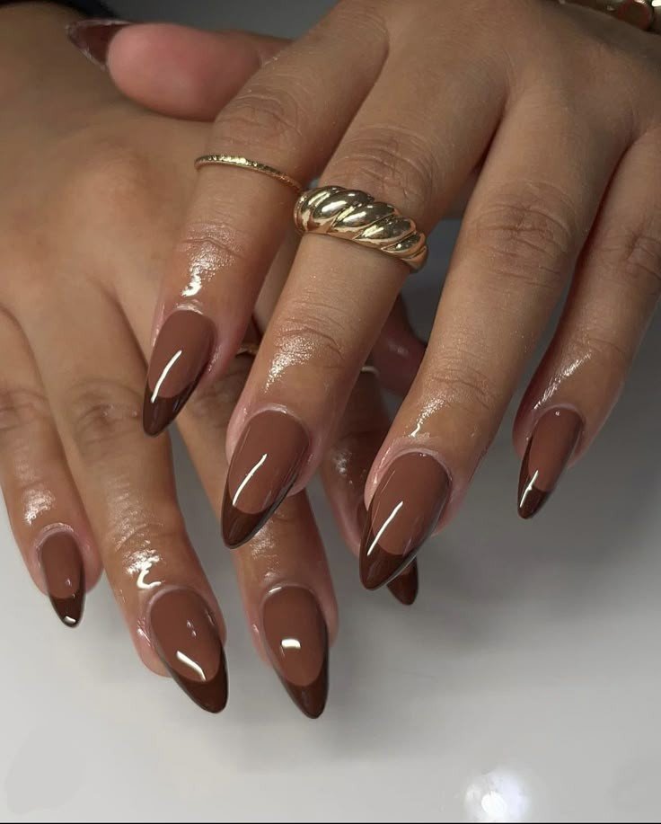 Almond nails with nude base and dark espresso brown French tips