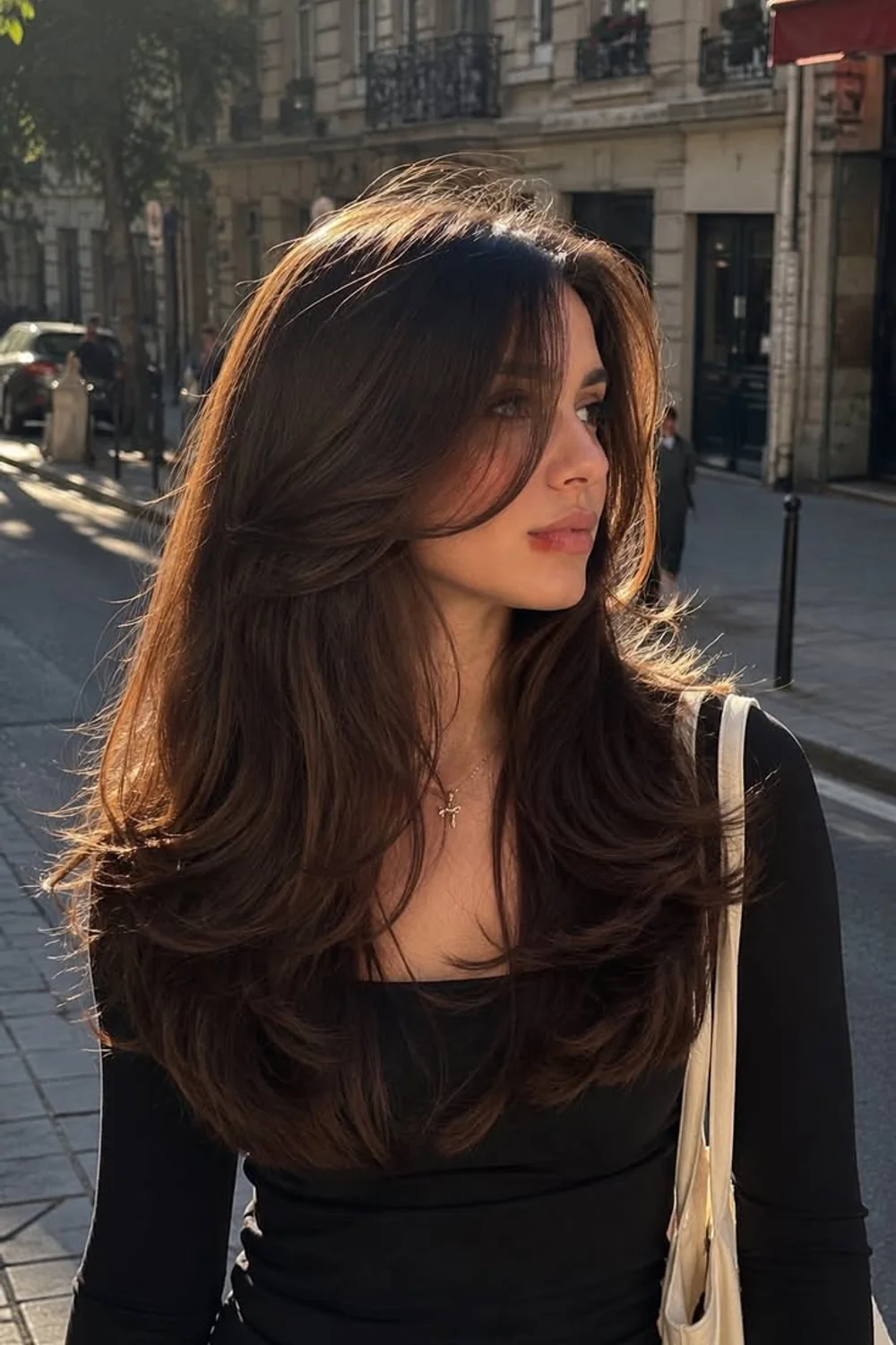 Long textured shag haircut with soft curtain fringe on chocolate brown hair