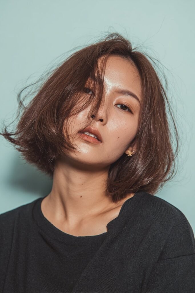 Choppy dark bob with long side-swept bangs