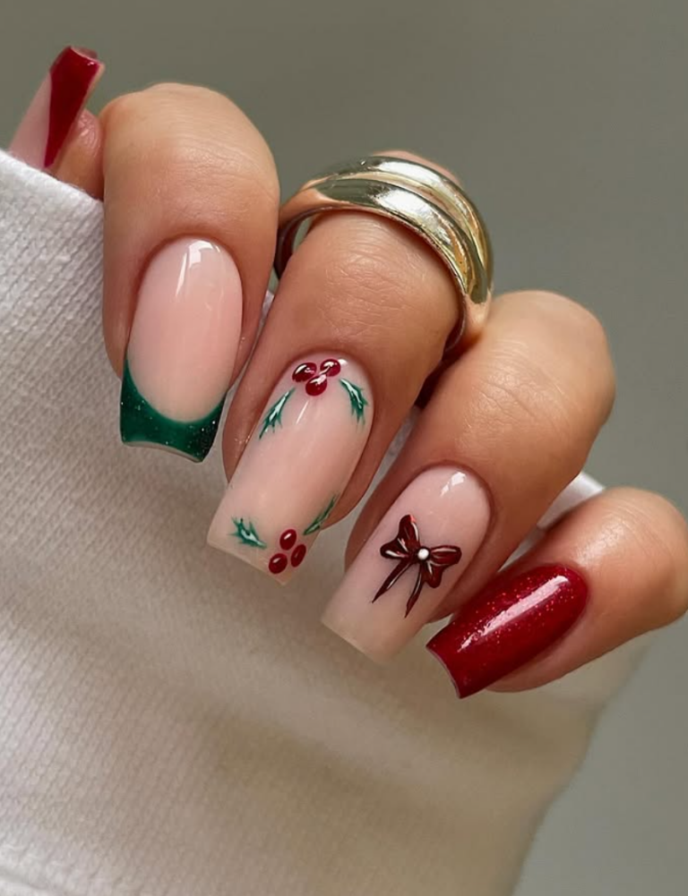 Forest-green French tips with a red bow accent and holly-berry details