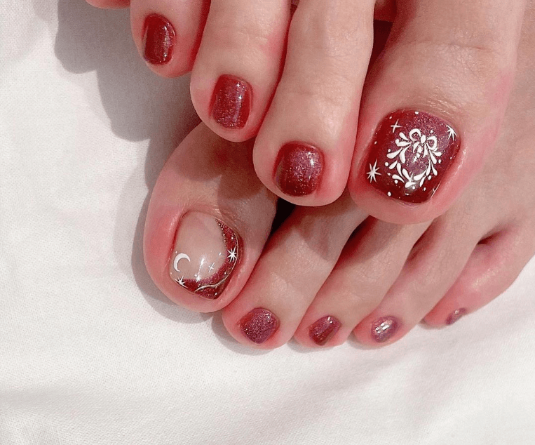 Red glitter pedicure with white bow, stars and crescent moon art on accent toes