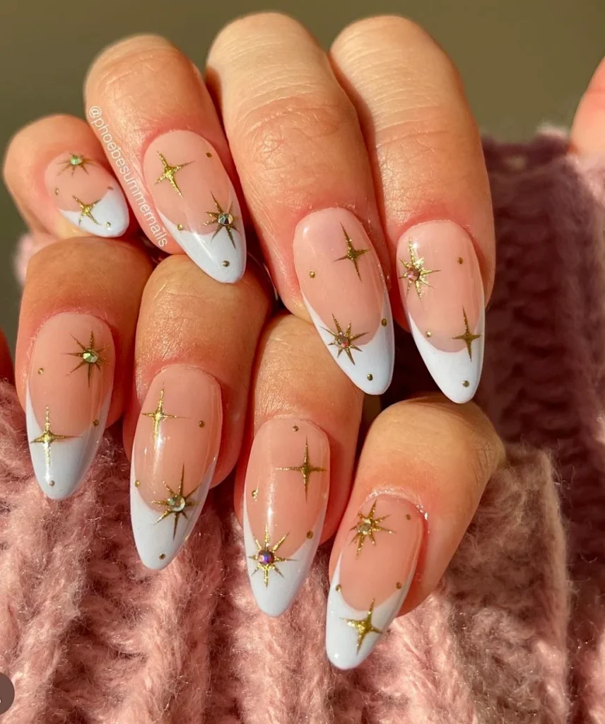 Nude Christmas nails with gold star confetti