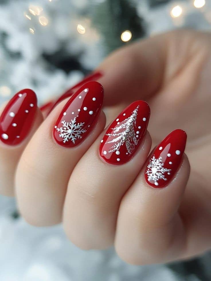 Deep red almond nails with white snowflakes, silver Christmas tree and dot snow art