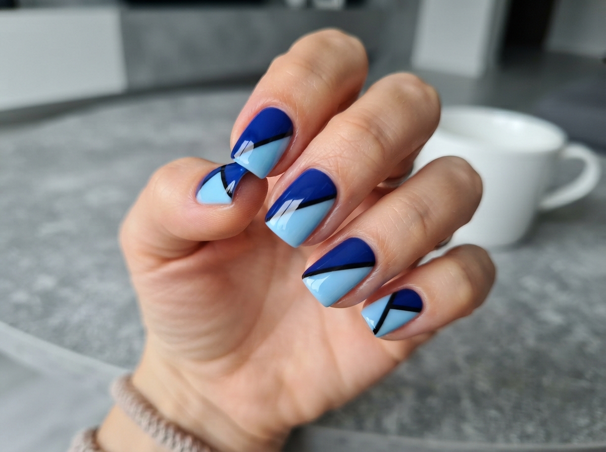 Short squoval nails with navy and light blue diagonal color blocks