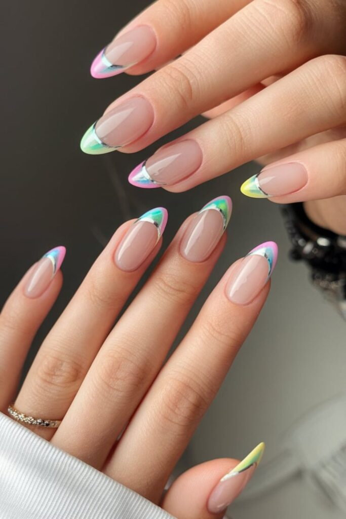 Nude nails with holographic chrome French tips shifting through rainbow colors