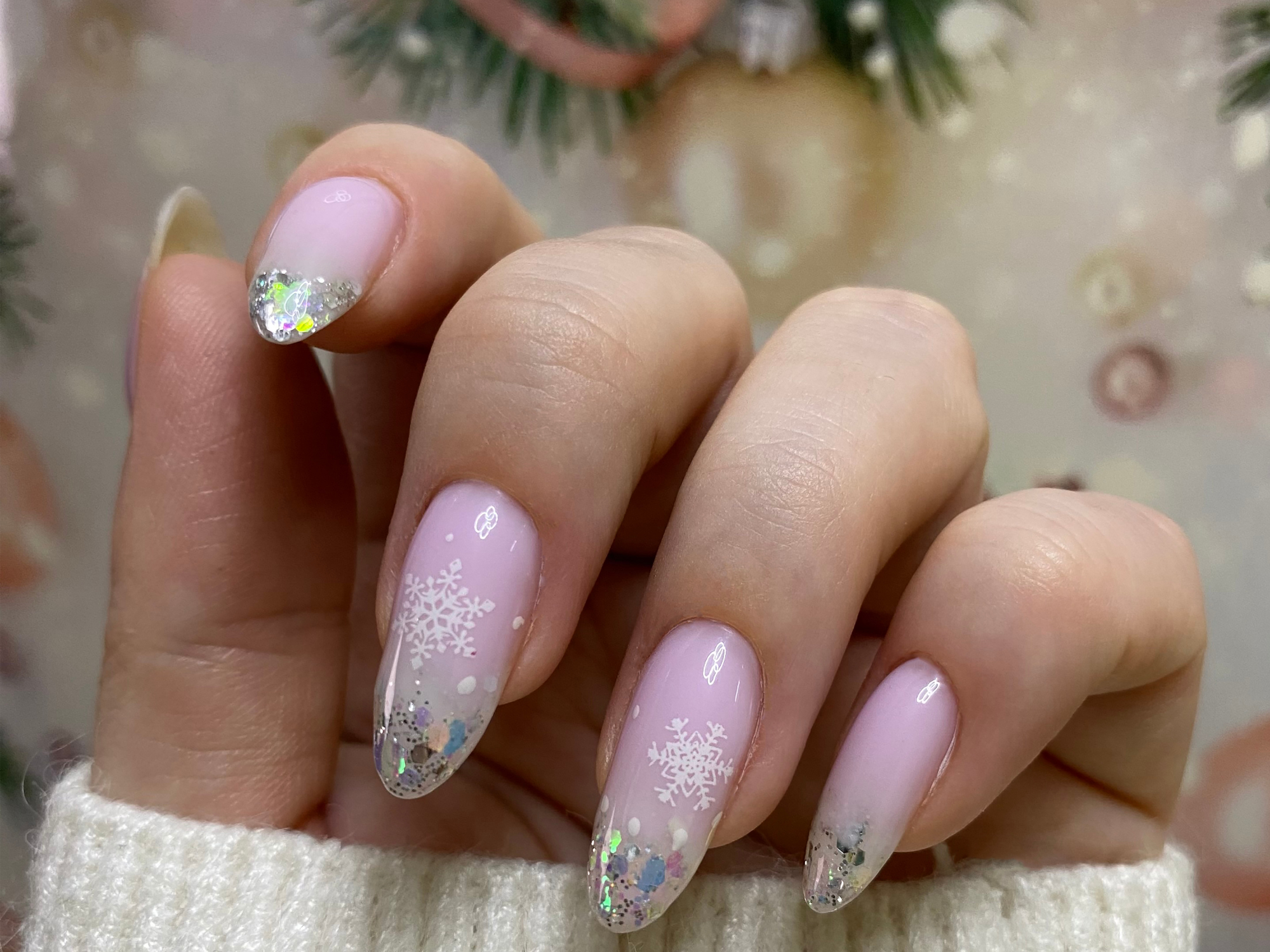 Sheer pink gradient nails with snowflake decals
