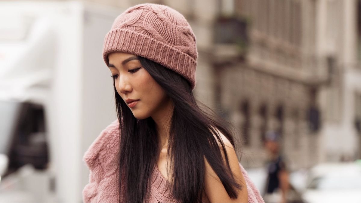 Woman in a pink beanie with long sleek straight black hair