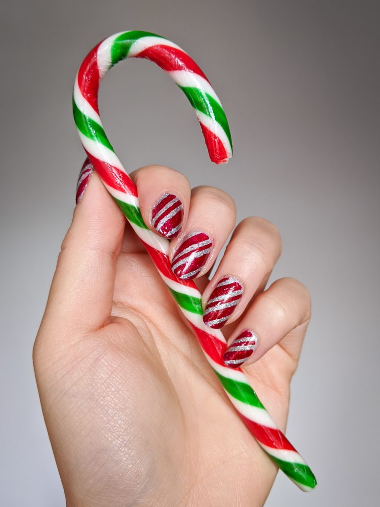 Candy cane stripe Christmas nail art in red and white