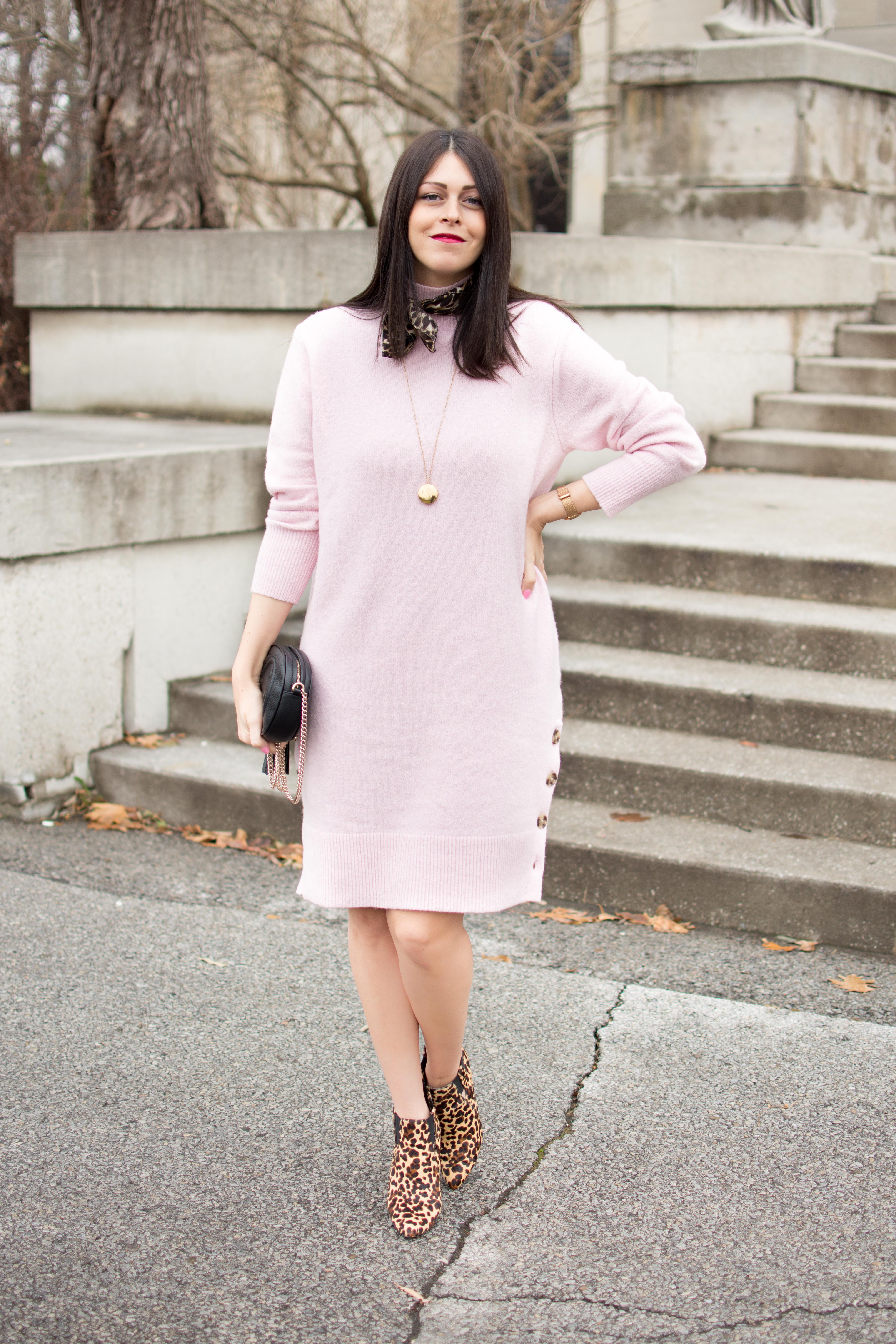 Blush pink knit sweater dress with side buttons, leopard-print ankle boots, a leopard scarf, a pendant necklace and a black round bag