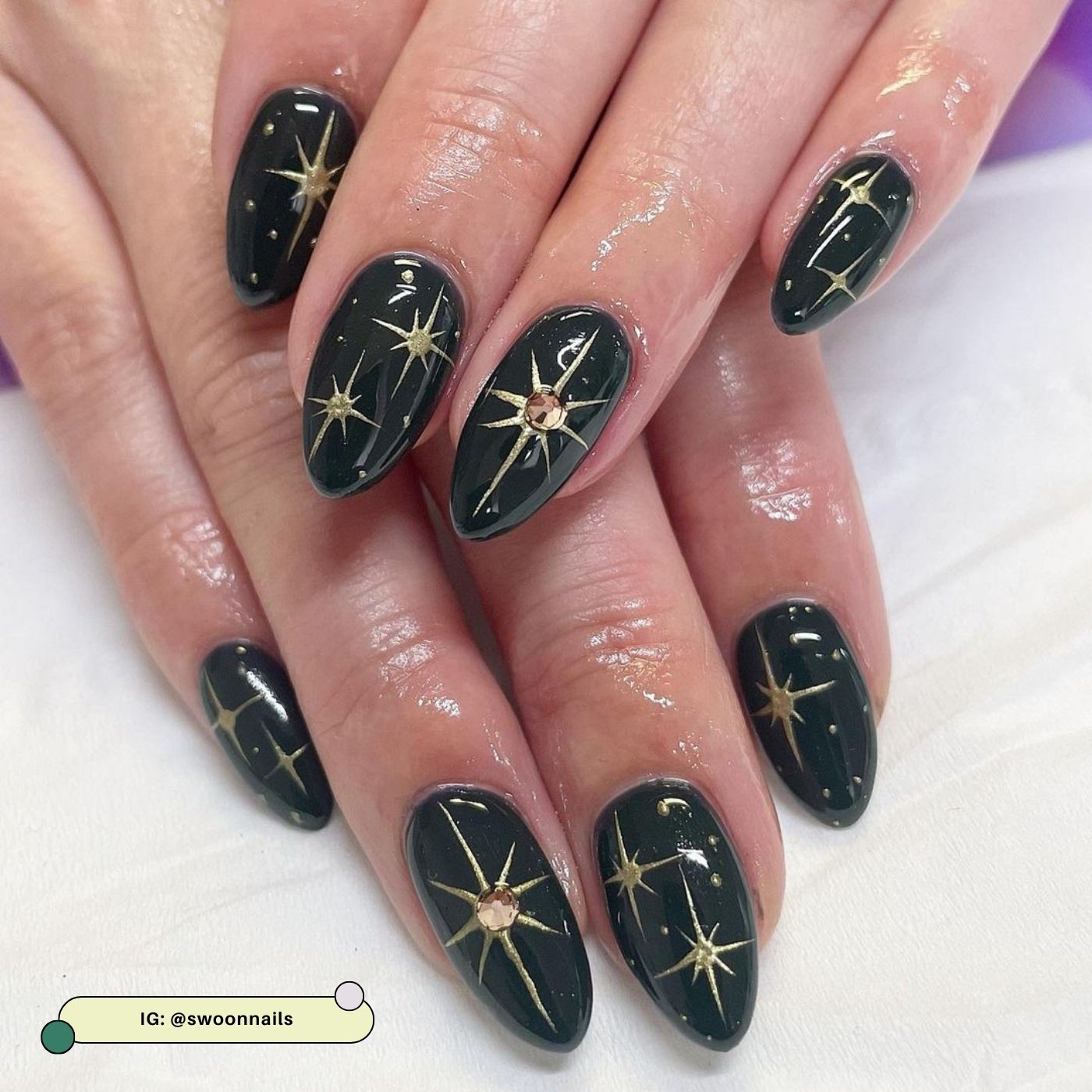 Dark evergreen nails with gold star accents