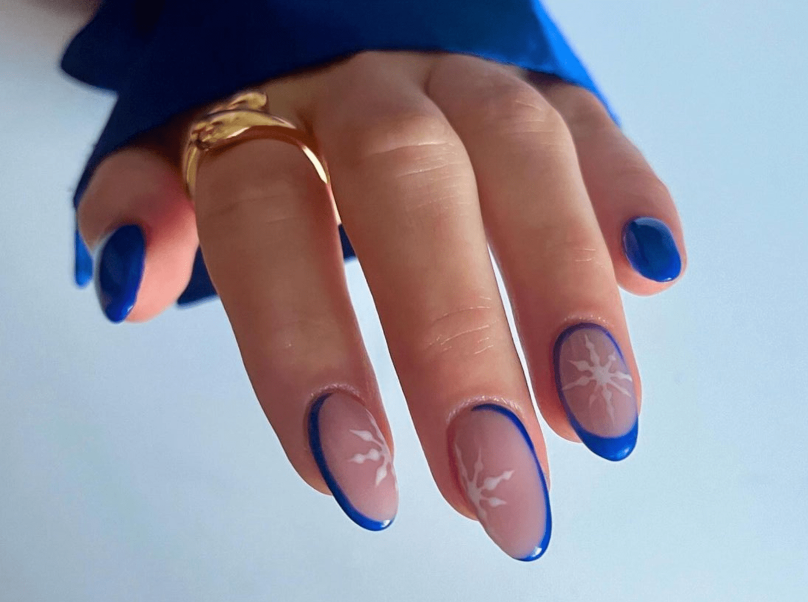 Medium almond nails in icy blue with white snowflake nail art