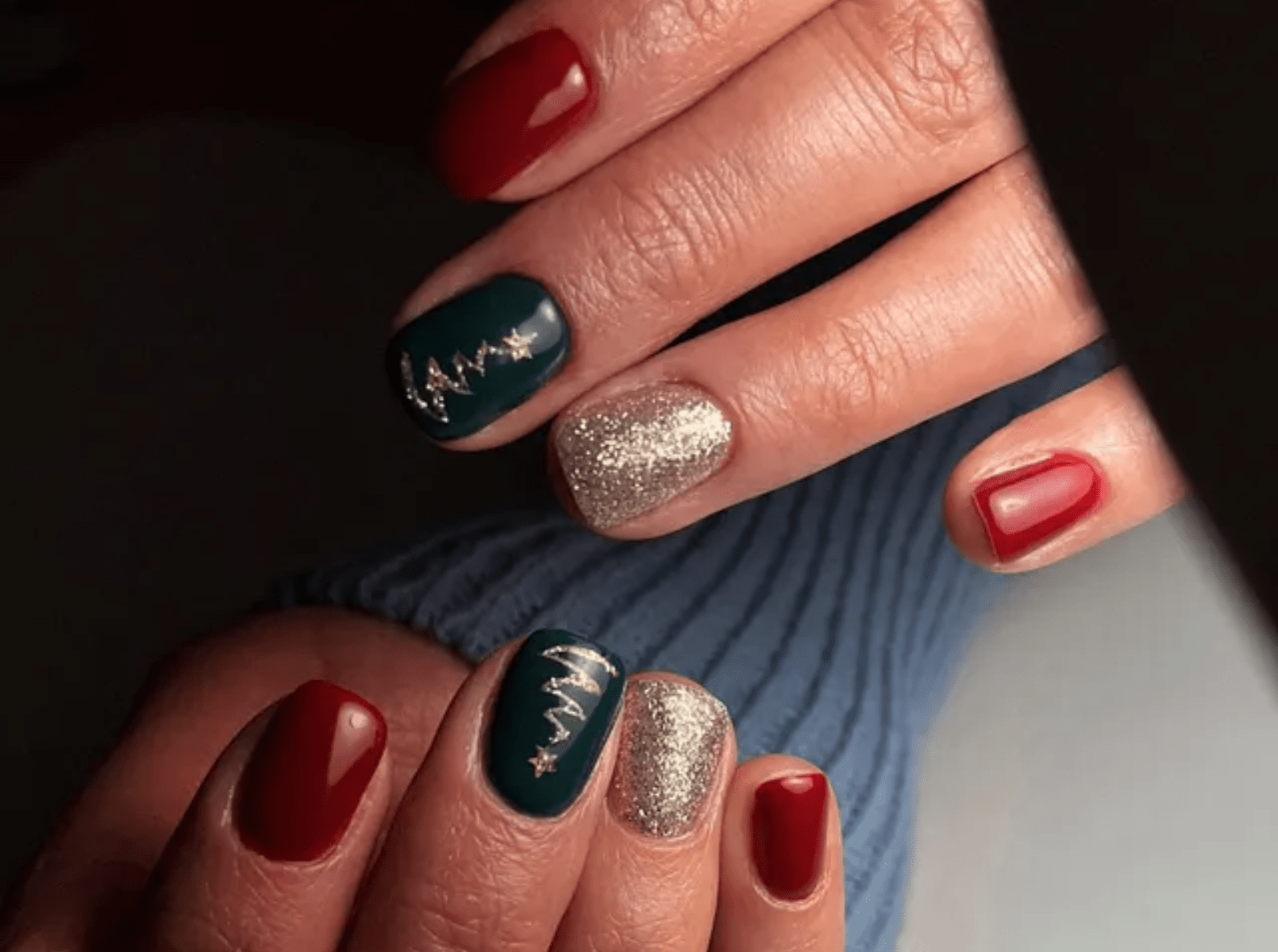 Medium almond nails in red, green and gold glitter with a Christmas tree accent nail