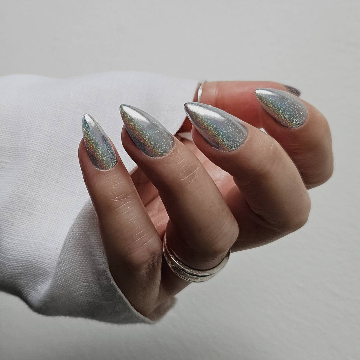 Almond nails with iridescent holographic chrome finish