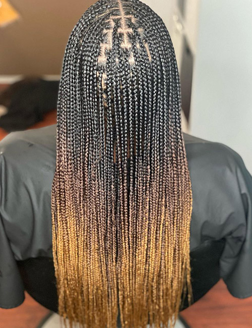 Long knotless box braids with warm ombré ends
