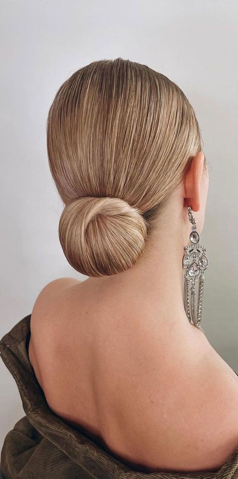 Woman with an elegant knot bun and center part hairstyle
