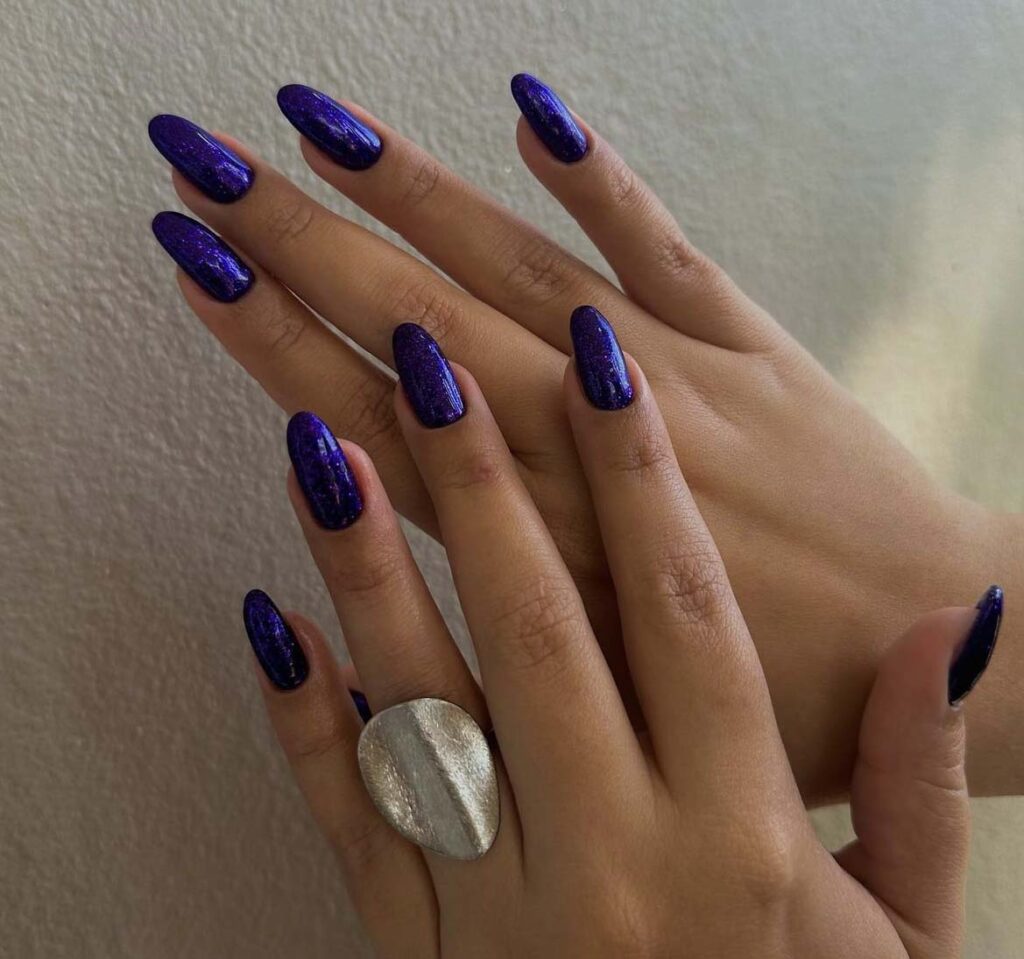 Almond nails in deep violet with a fine all-over shimmer