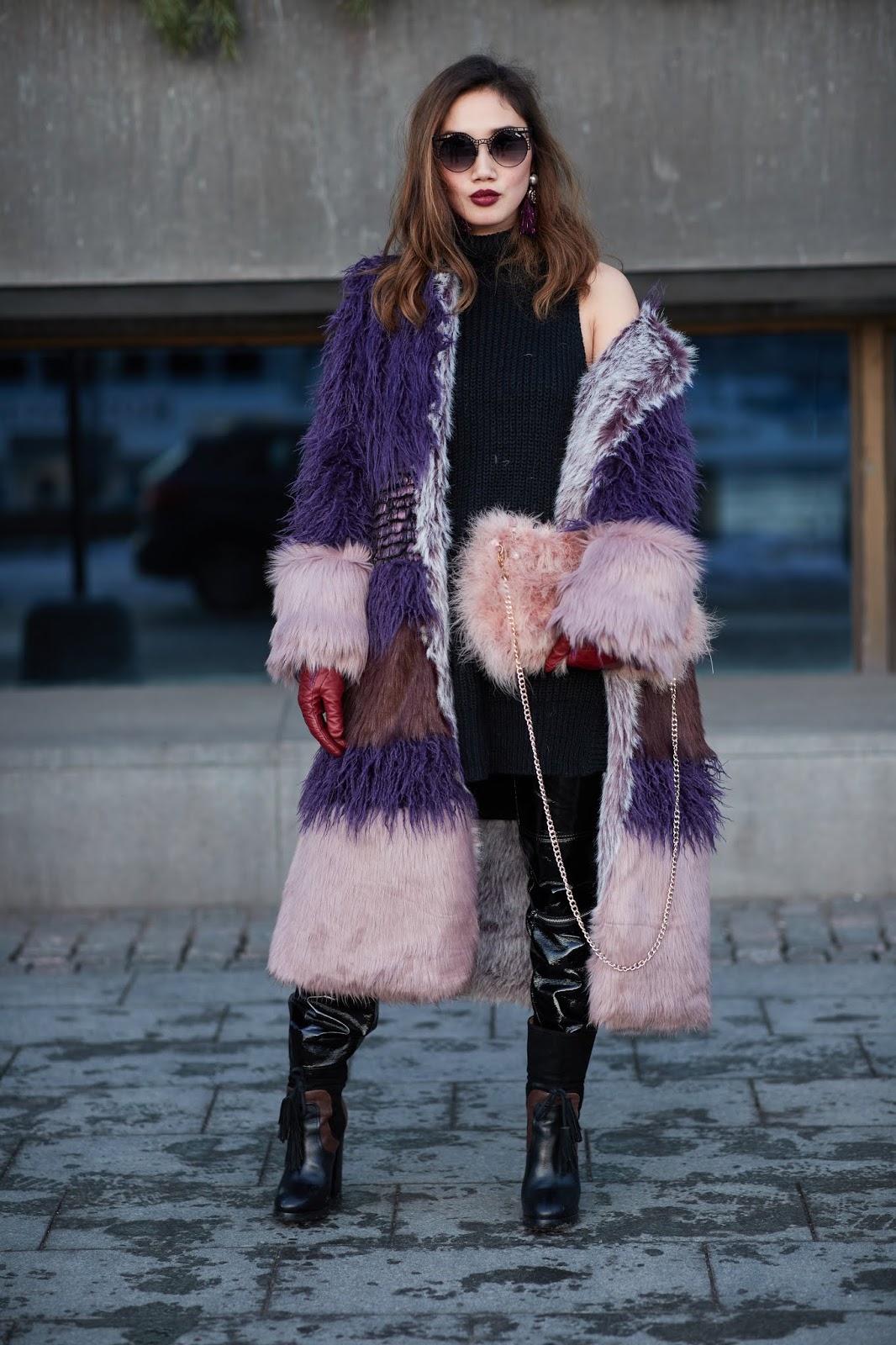Woman in a faux fur coat over a dress with knee-high boots