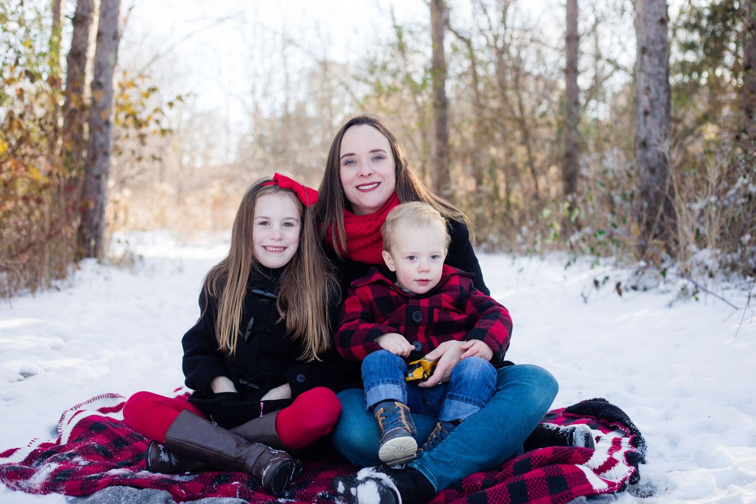Family wrapped in oversized scarves in a winter photoshoot