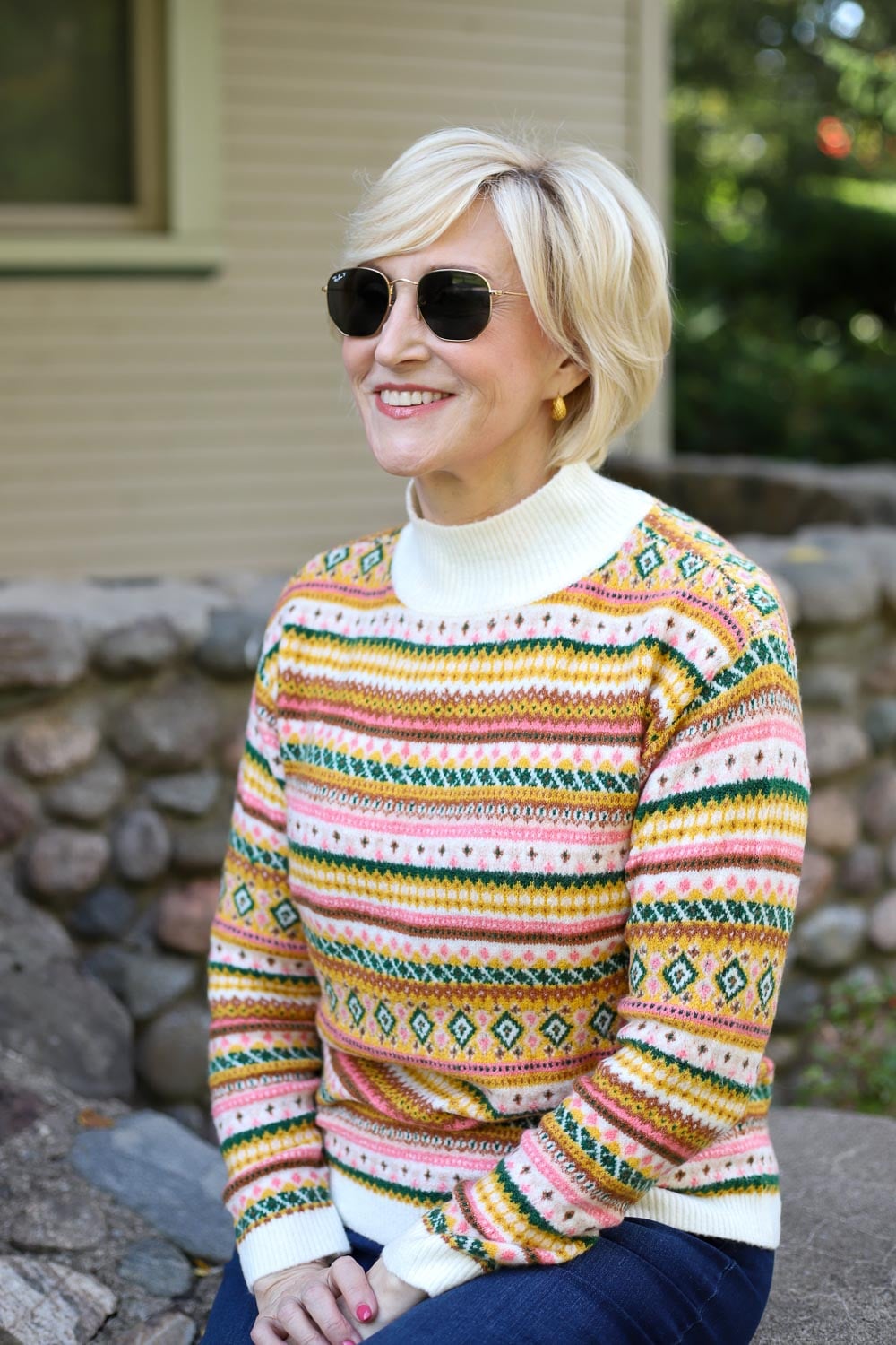 Woman wearing a traditional fair-isle sweater with black jeans