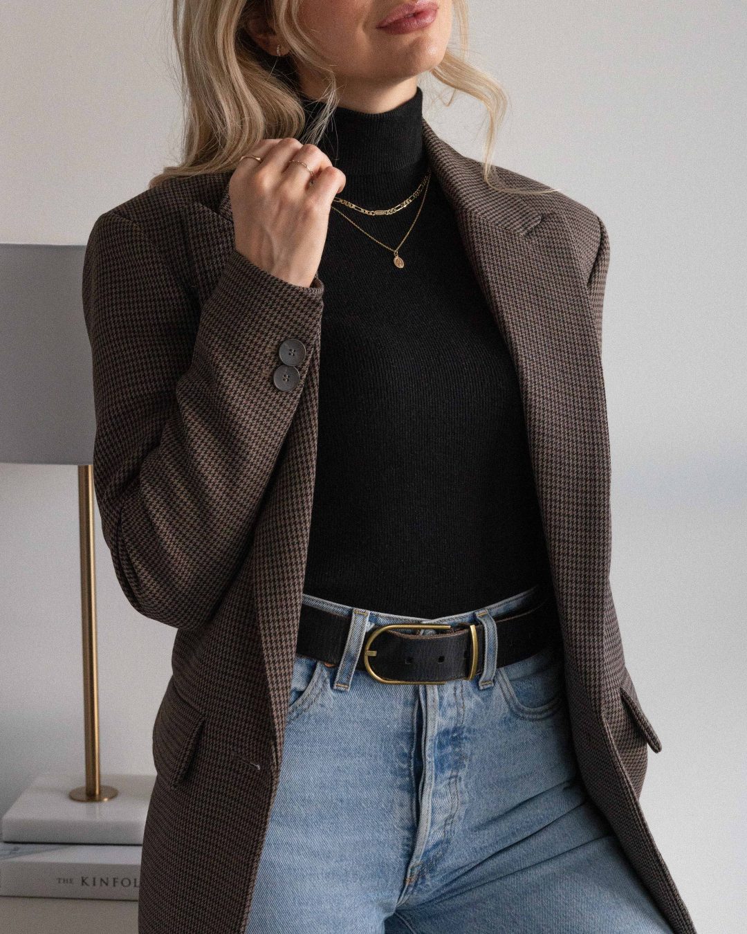 Woman in a plaid blazer with turtleneck and jeans