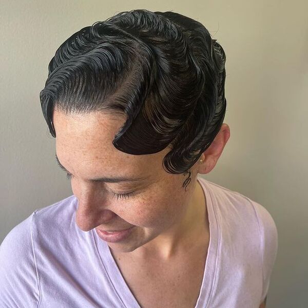 Sculpted vintage finger waves on dark hair with deep side part