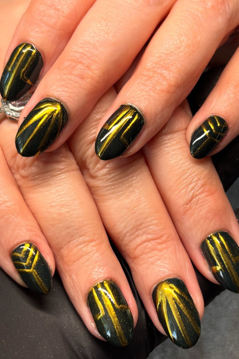 Forest green nails with gold geometric line art