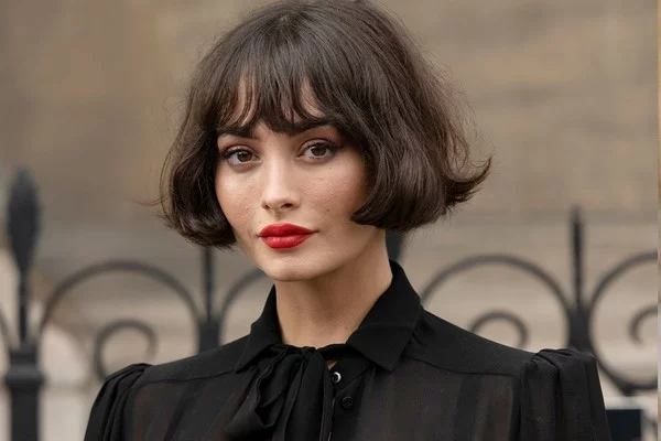 Dark brown French bob with wispy bangs and rounded ends