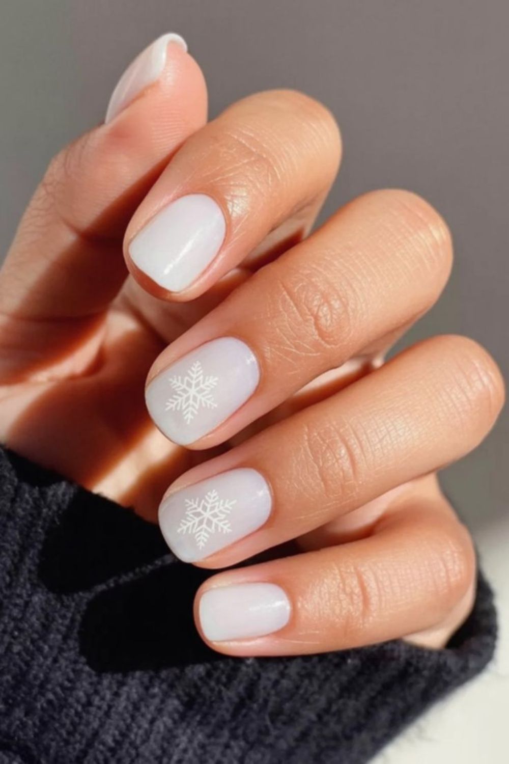 Sheer milky white nails with faint snowflake art