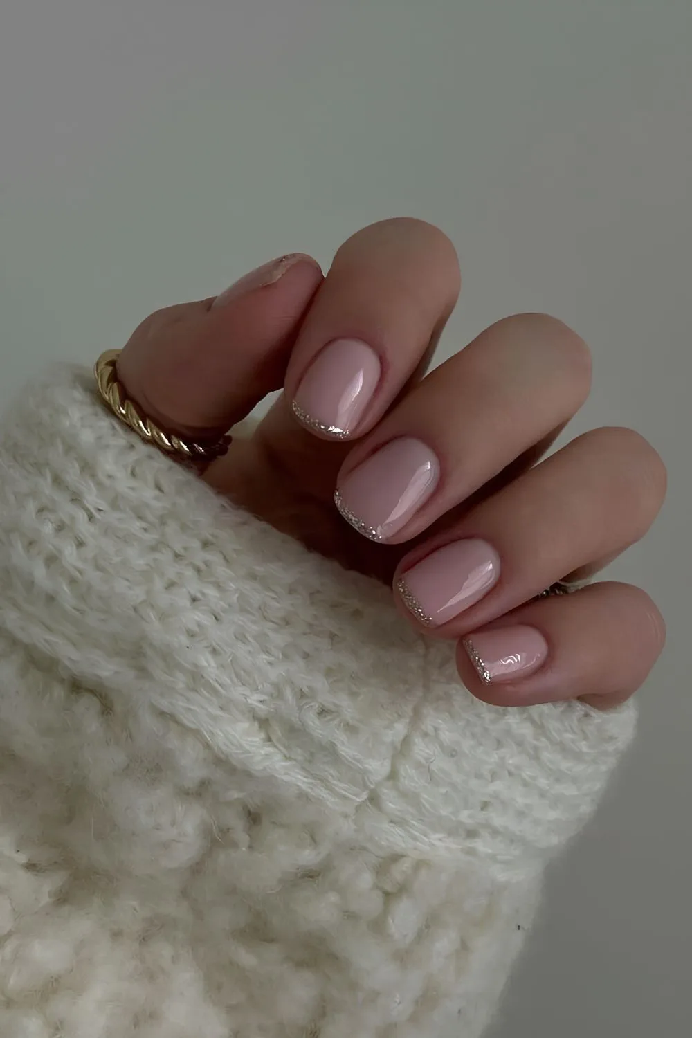 Sheer pink nails with silver glitter micro-french tips