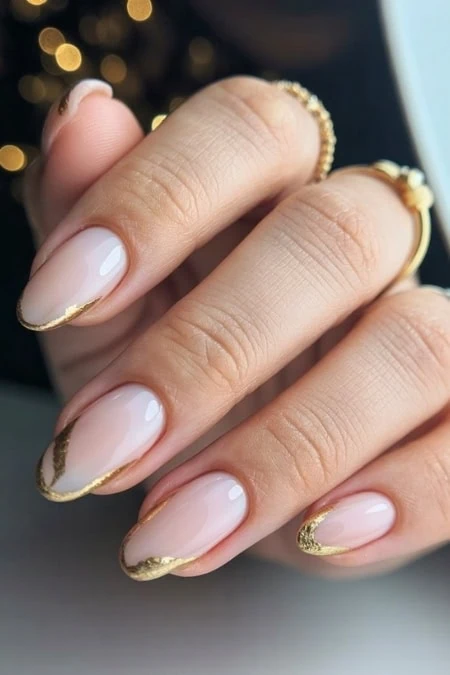 Almond milky nude nails with textured gold foil French tips