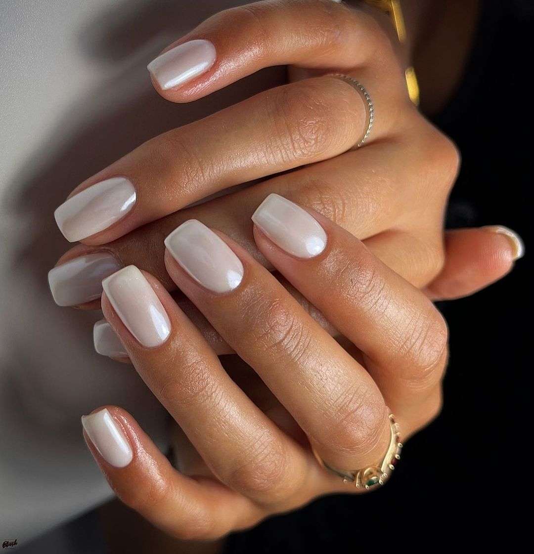 Milky white nails with a glazed donut shimmer finish