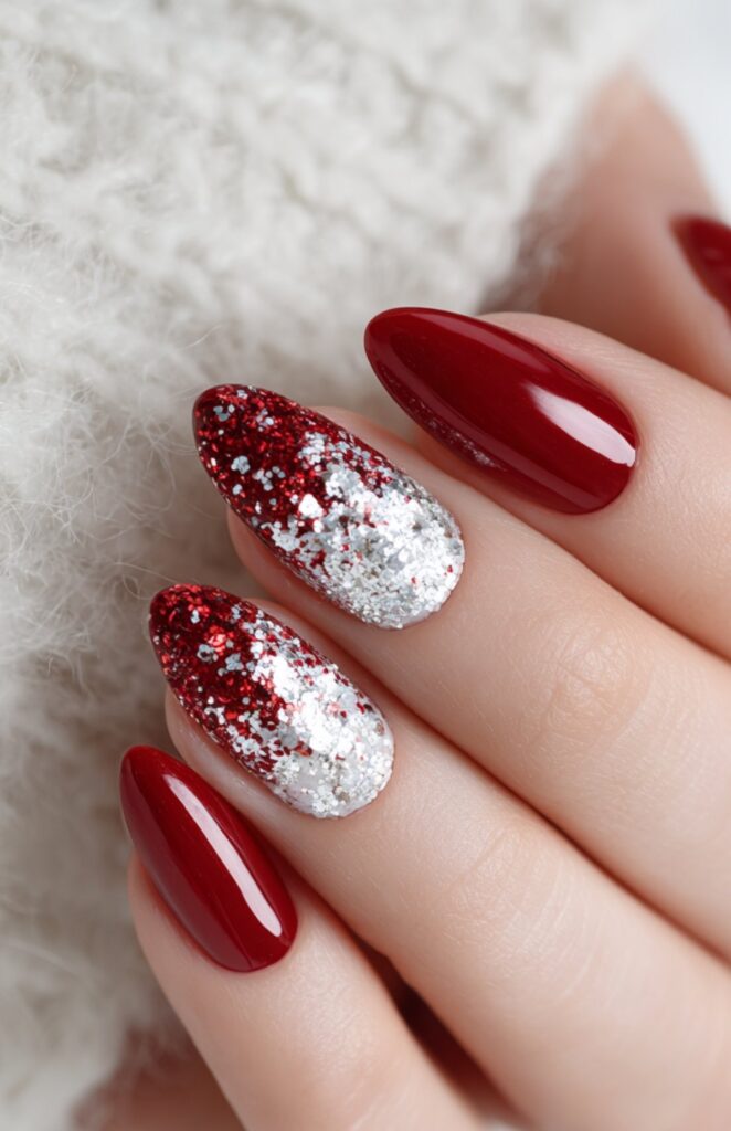 Red glitter nails with white sparkle accents in a Christmas manicure