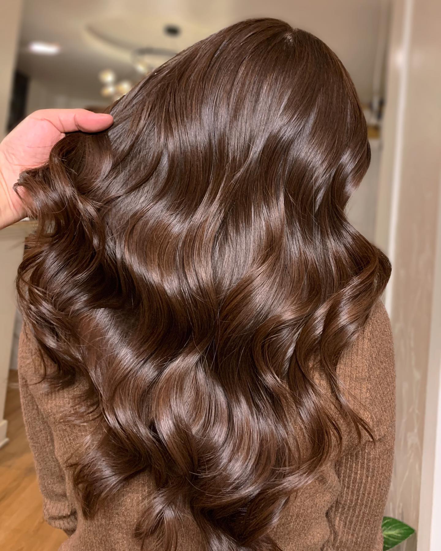 Side and back view of long polished espresso brown waves with mirror-like shine