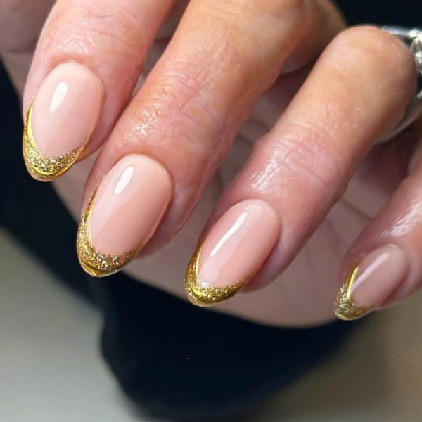 Gold glitter French tip nails with shimmering metallic gold tips