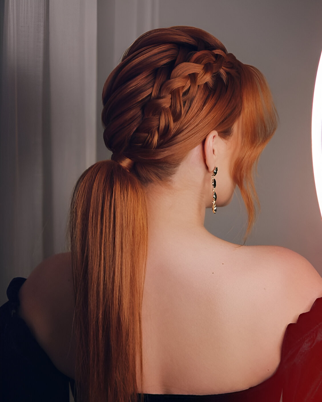 Low ponytail on copper-red hair with a braid woven from the crown into the ponytail base.