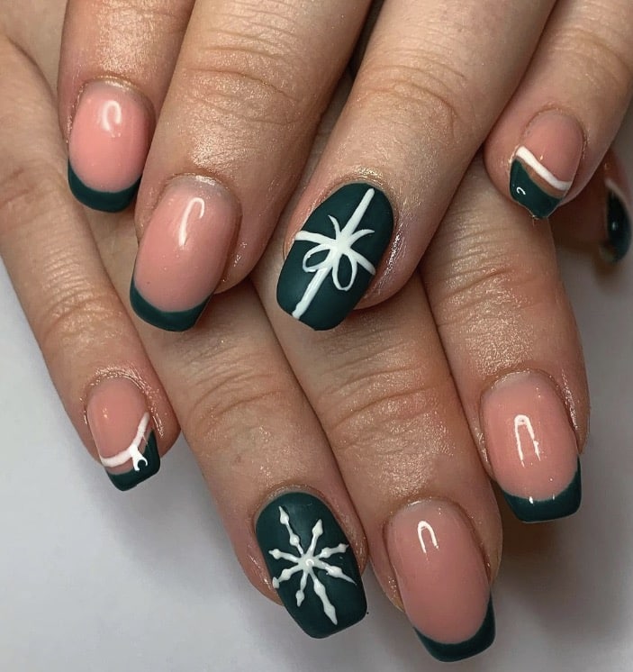 Forest green French tip nails with gift bow and snowflake accents