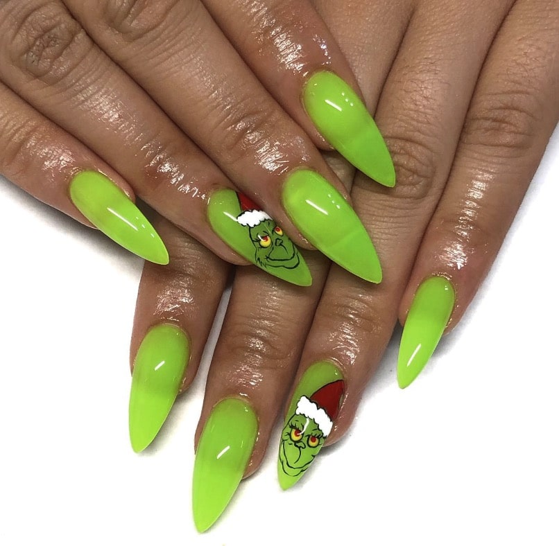 Square nails with green French tips and a Grinch accent nail