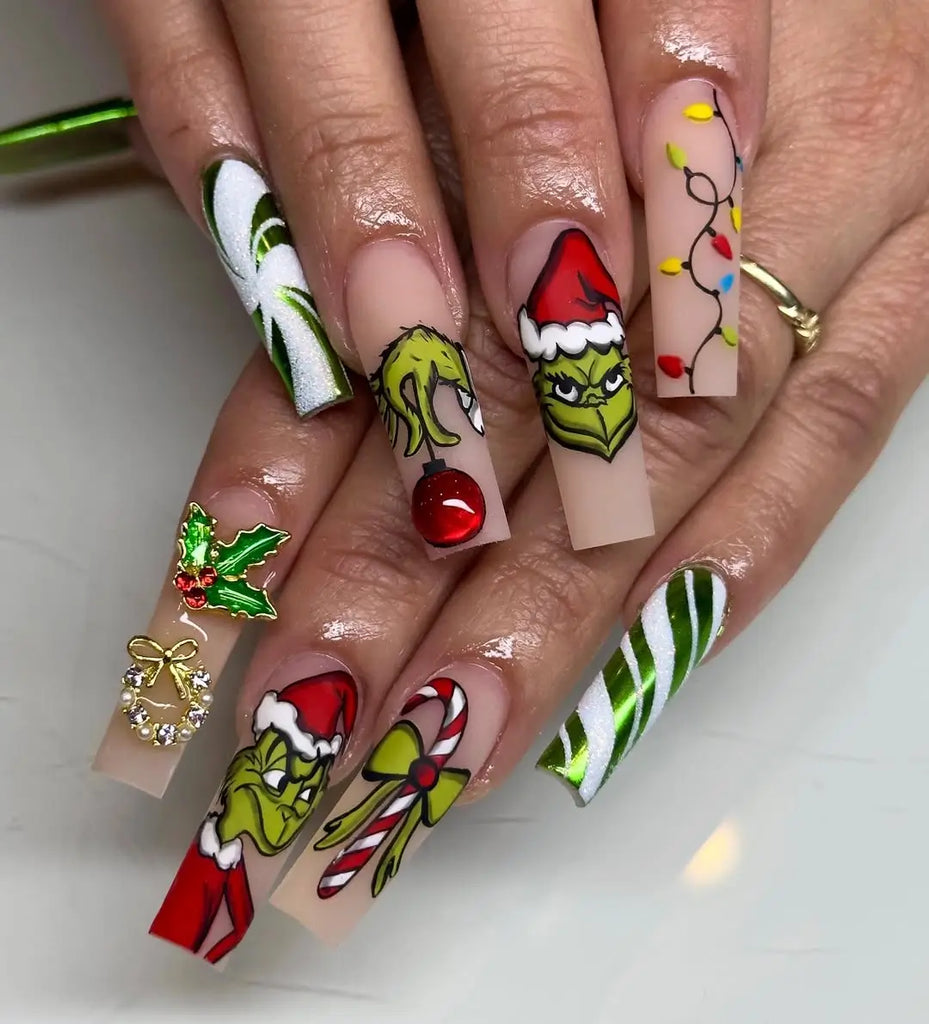 Long square nails pairing Santa-suit red with Grinch character art