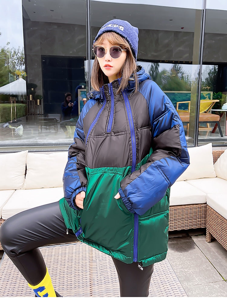 A woman wearing a color-block long puffer jacket with winter base layers