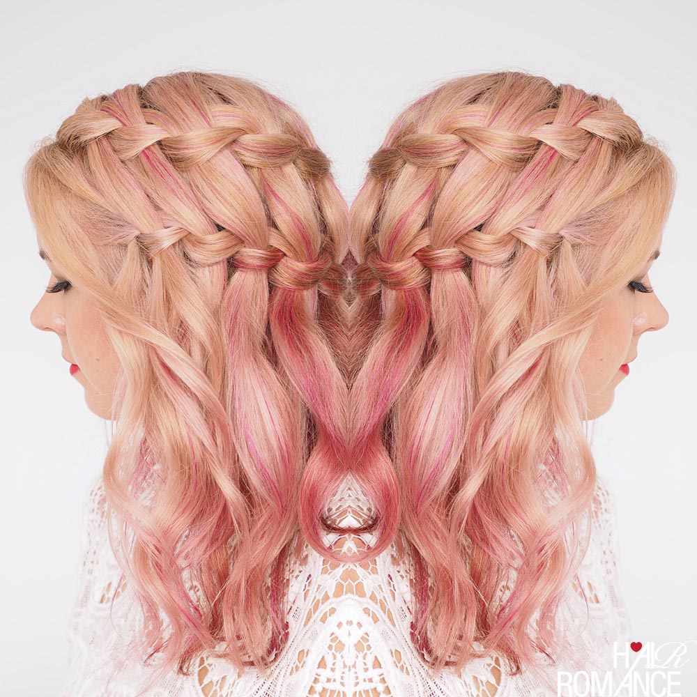 Double waterfall braid with cascading strands in pink-toned hair