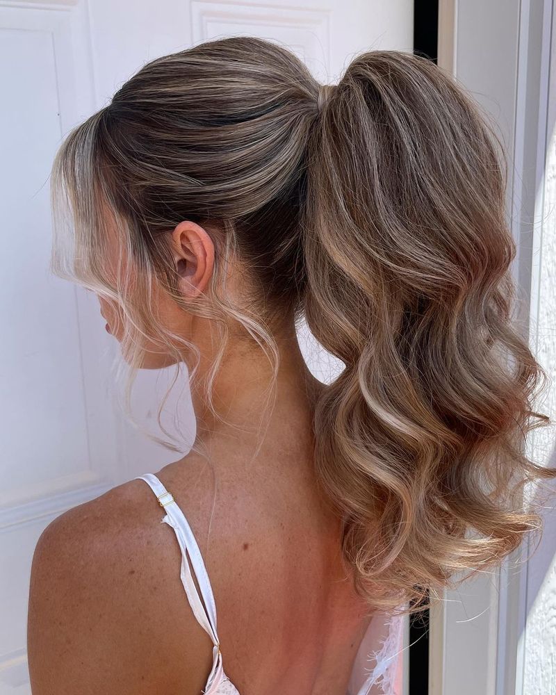 A high ponytail with cascading brushed-out waves