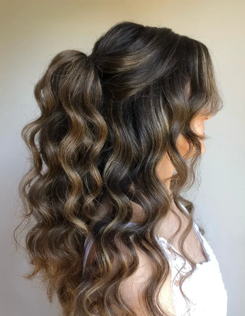 Curly half-up half-down hairstyle with volume at the crown